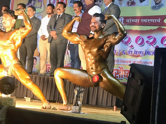 SPARTANS Dombivli bodybuilder posing beside his trophy on stage